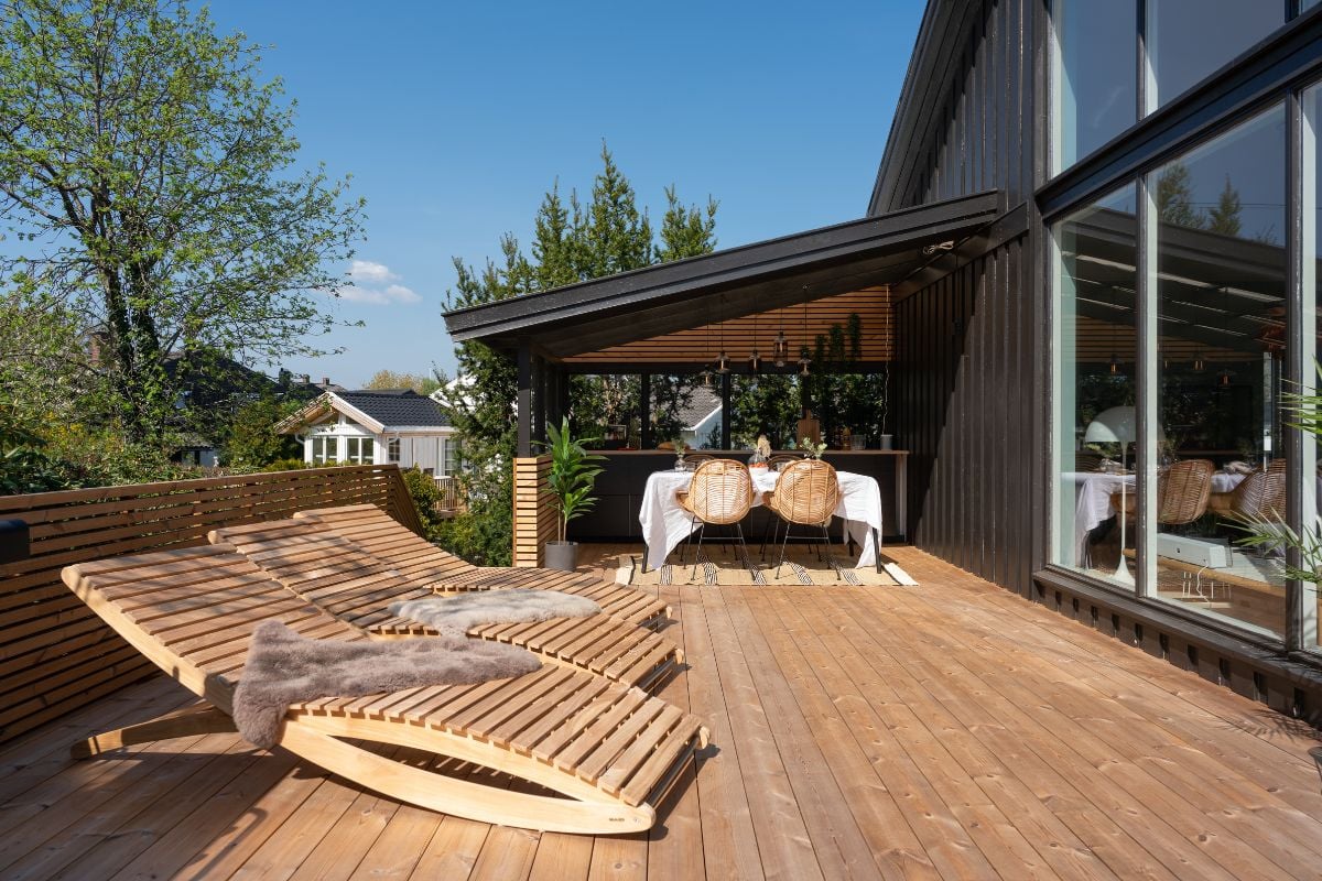 Solfylt terrasse med solsenger av tre